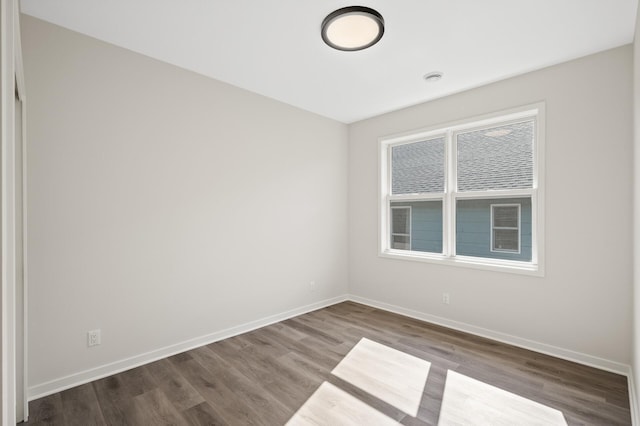 unfurnished room featuring dark hardwood / wood-style floors