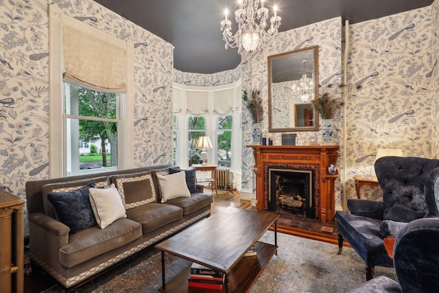 living room with a wealth of natural light, hardwood / wood-style floors, and a chandelier