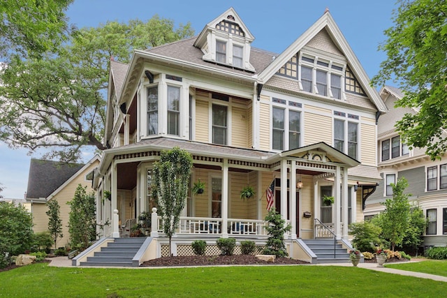 victorian home with covered porch and a front lawn