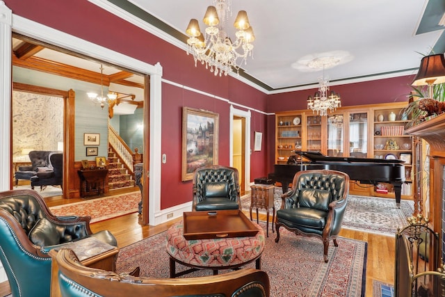 living room with hardwood / wood-style floors, ornamental molding, and a notable chandelier