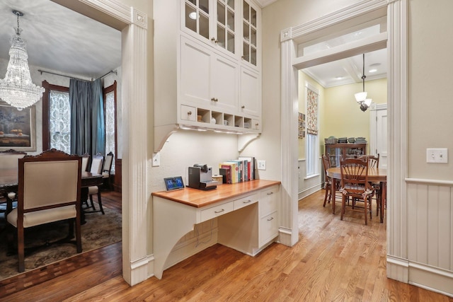 kitchen featuring wooden counters, white cabinets, pendant lighting, and light hardwood / wood-style flooring