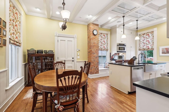 dining area featuring sink, a healthy amount of sunlight, and light hardwood / wood-style floors