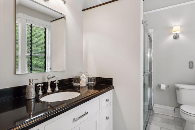 bathroom with tile patterned floors, a shower with door, vanity, and toilet