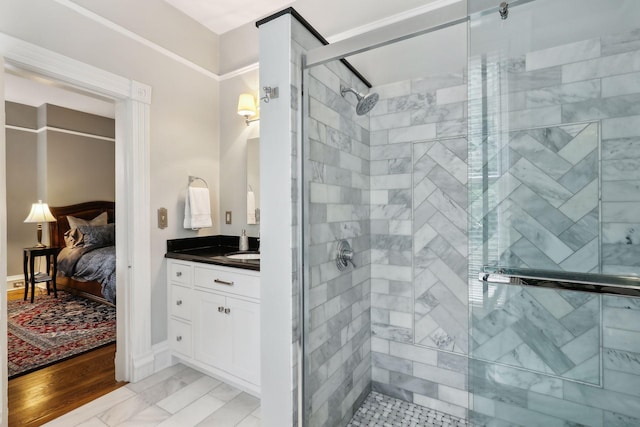 bathroom with wood-type flooring, vanity, and a shower with shower door