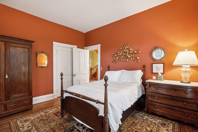 bedroom with dark hardwood / wood-style floors