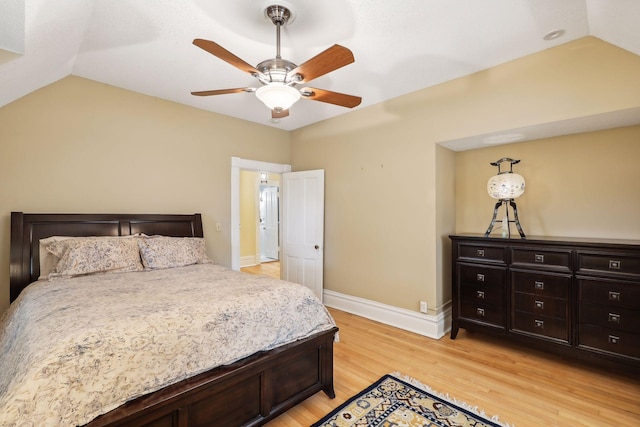 bedroom featuring ceiling fan, light hardwood / wood-style floors, and lofted ceiling