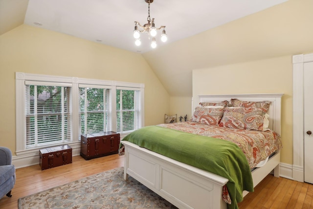 bedroom with multiple windows, vaulted ceiling, and light wood-type flooring