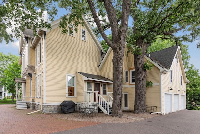 back of property featuring a garage