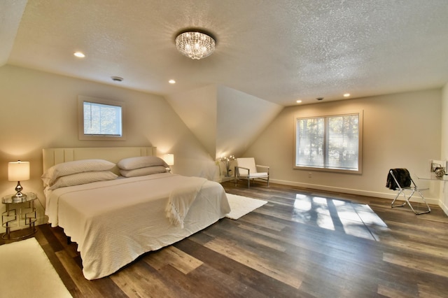 bedroom with vaulted ceiling, a notable chandelier, a textured ceiling, and dark hardwood / wood-style flooring