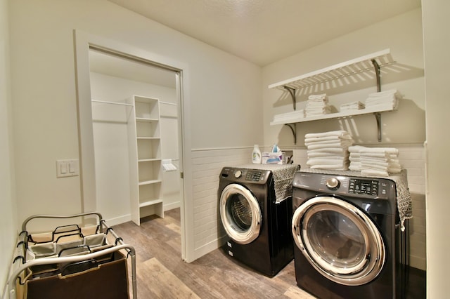 laundry area featuring separate washer and dryer and light wood-type flooring