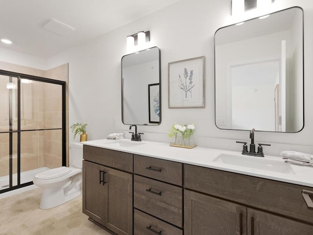 bathroom featuring toilet, vanity, and walk in shower