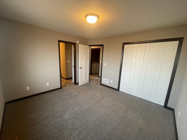 unfurnished bedroom with dark carpet and a closet