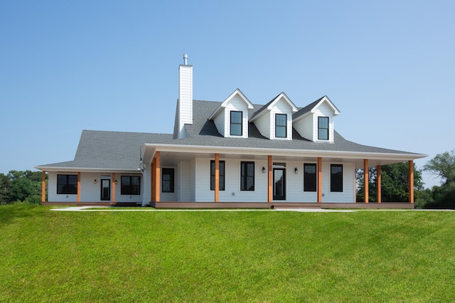 view of front of home with covered porch and a front yard