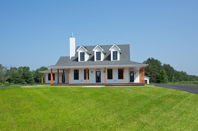 view of front of house featuring covered porch and a front lawn