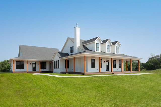 farmhouse inspired home featuring a front yard and covered porch