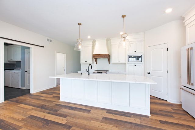 kitchen with white cabinets, decorative light fixtures, custom exhaust hood, and dark hardwood / wood-style flooring