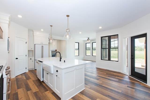 kitchen featuring ceiling fan, pendant lighting, dark hardwood / wood-style floors, and white cabinetry