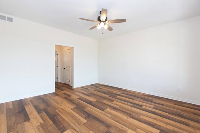 spare room featuring ceiling fan and dark wood-type flooring