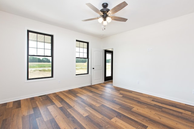 spare room featuring ceiling fan and dark hardwood / wood-style flooring