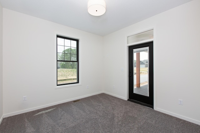 empty room featuring dark carpet