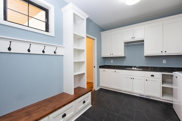 interior space featuring dark tile flooring and sink