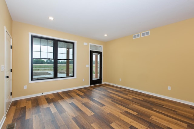 spare room with dark hardwood / wood-style flooring