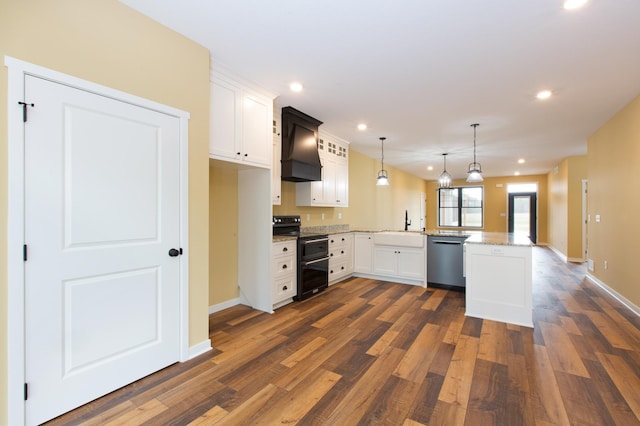 kitchen featuring range with two ovens, white cabinets, decorative light fixtures, and kitchen peninsula