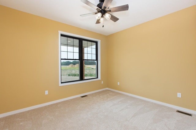 unfurnished room with ceiling fan and light colored carpet