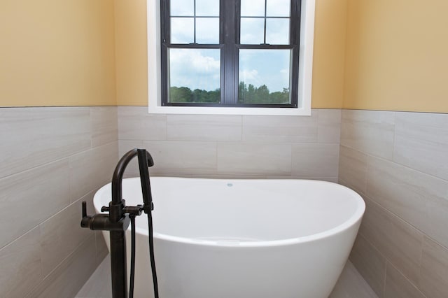 bathroom with tile walls