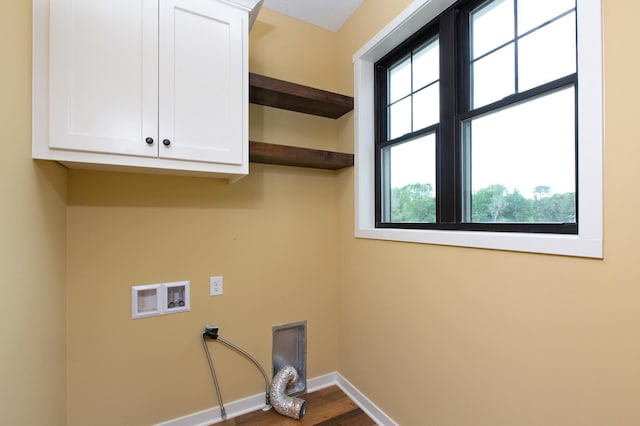 laundry room with electric dryer hookup, cabinets, hardwood / wood-style flooring, and hookup for a washing machine