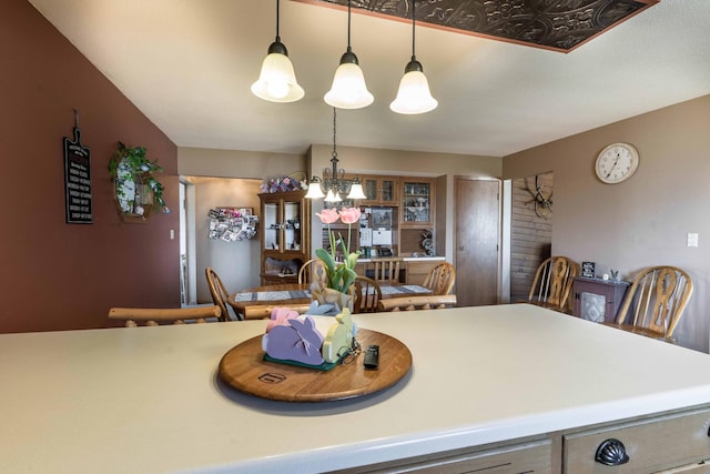 kitchen featuring pendant lighting and a notable chandelier