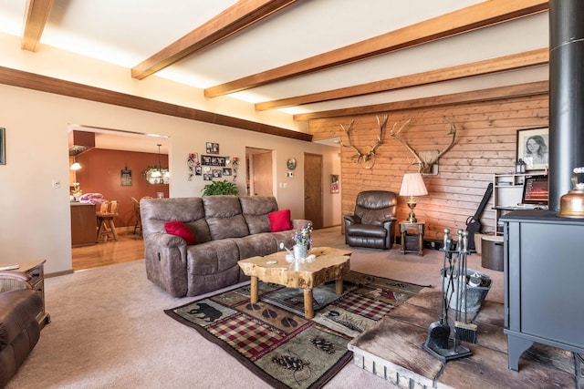 living room with beam ceiling, carpet floors, and wooden walls