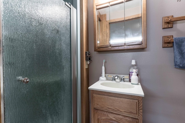 bathroom with vanity and a shower with shower door