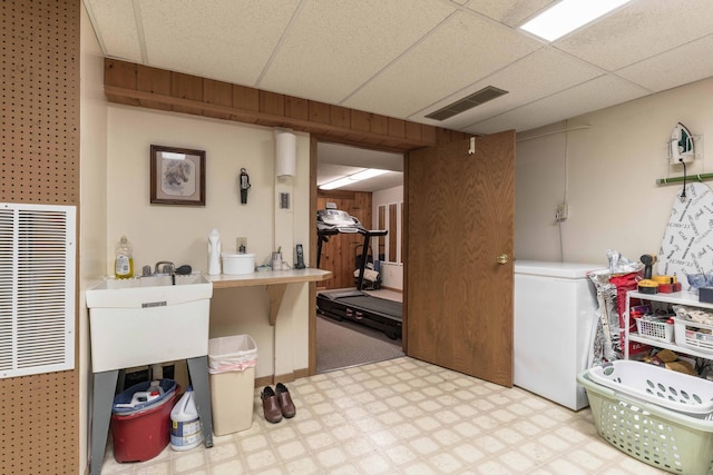 laundry area featuring wooden walls