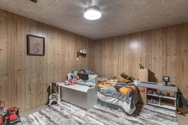 bedroom with wooden walls and carpet floors