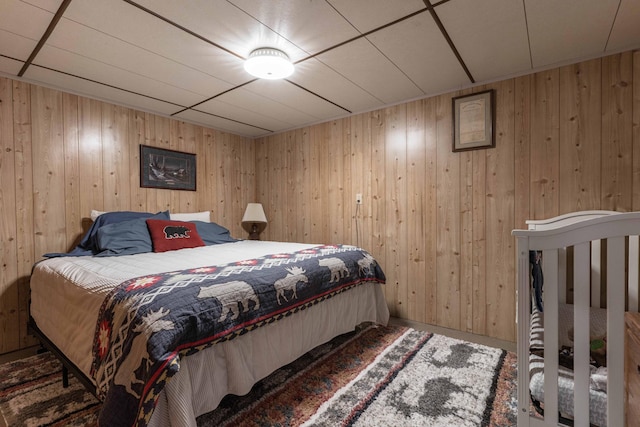 bedroom featuring wooden walls