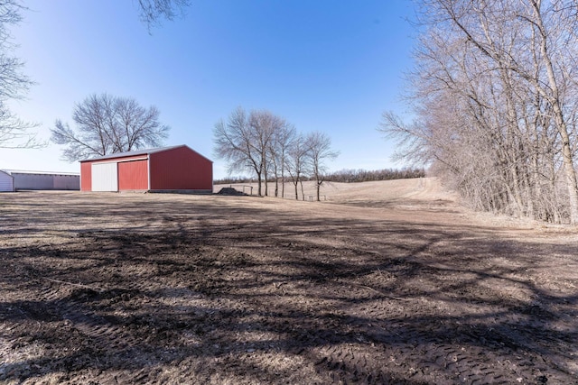 view of yard with a rural view and an outdoor structure