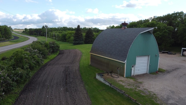 view of outdoor structure with a yard and a garage