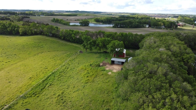 birds eye view of property featuring a water view and a rural view