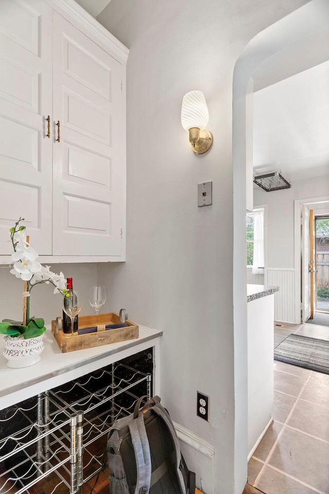 kitchen featuring tile flooring and white cabinets