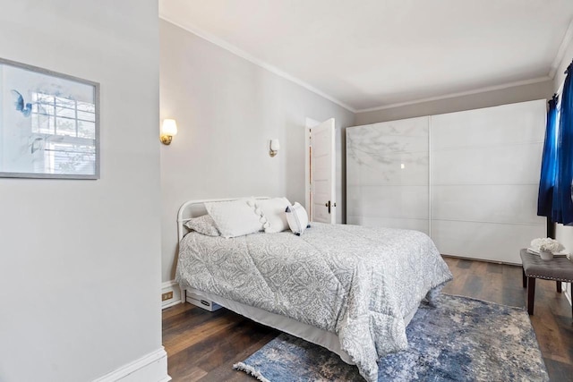 bedroom with crown molding and dark hardwood / wood-style floors