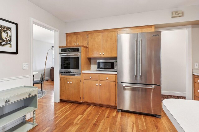 kitchen with stainless steel appliances and light wood-type flooring