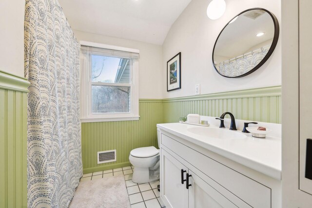 bathroom featuring tile flooring, oversized vanity, and toilet