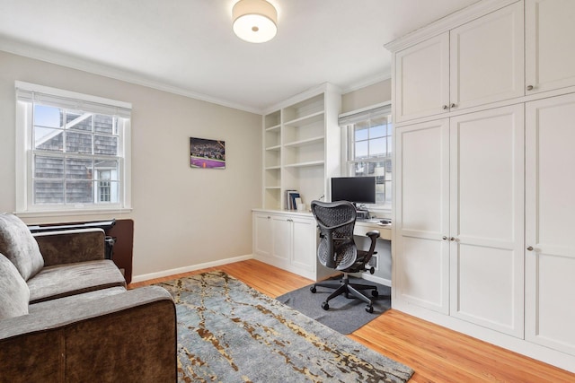 home office featuring ornamental molding and light hardwood / wood-style flooring