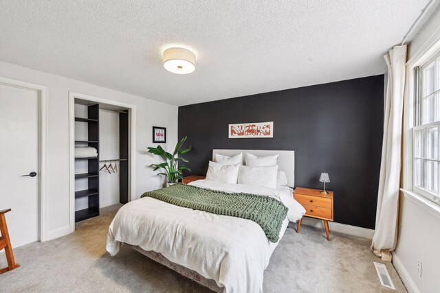 carpeted bedroom featuring a textured ceiling