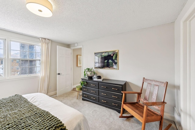 carpeted bedroom featuring a textured ceiling