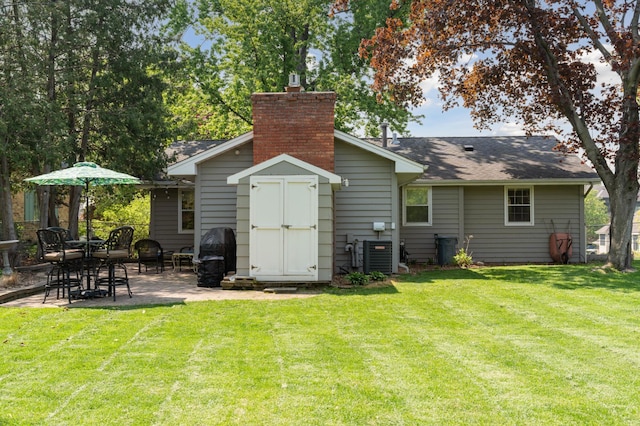 back of property with a patio, central AC unit, and a yard