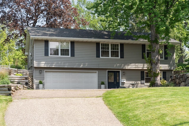 view of front of property with a garage and a front yard