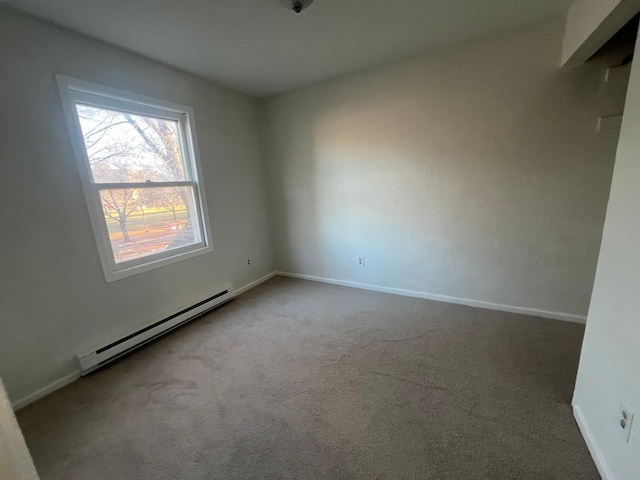 carpeted empty room featuring a baseboard radiator