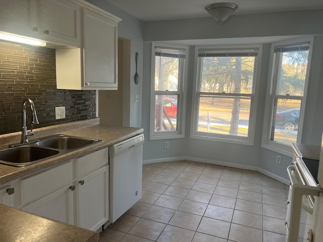 kitchen with sink, tasteful backsplash, light tile patterned flooring, white dishwasher, and white cabinets